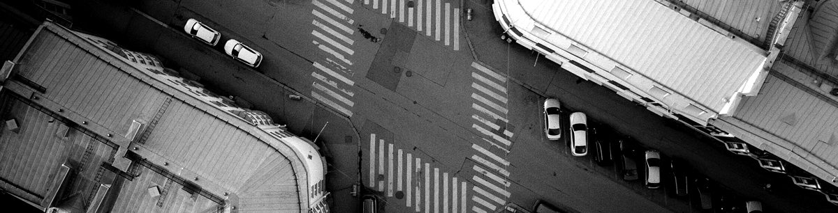 Overhead view of a street intersection and surrounding rooftops